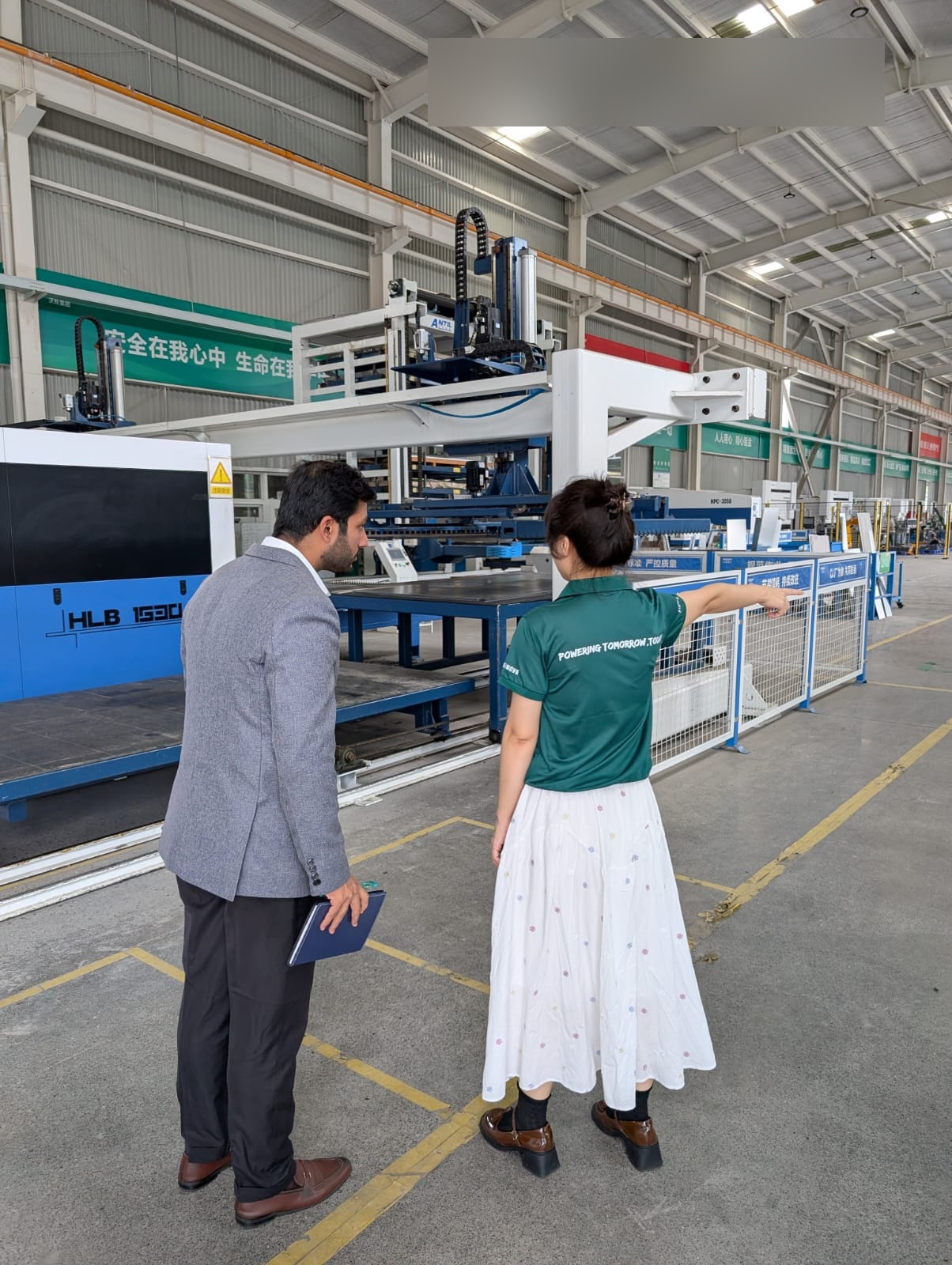 Charginity team member touring manufacturing equipment in China